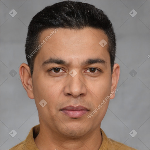 Joyful latino young-adult male with short  brown hair and brown eyes