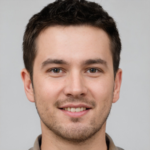 Joyful white young-adult male with short  brown hair and brown eyes