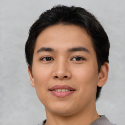 Joyful asian young-adult male with short  brown hair and brown eyes