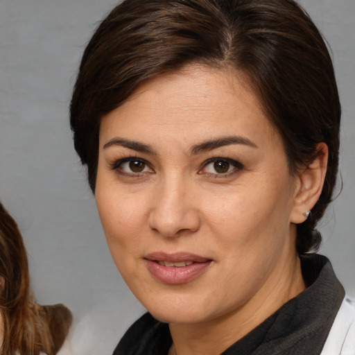 Joyful white adult female with medium  brown hair and brown eyes