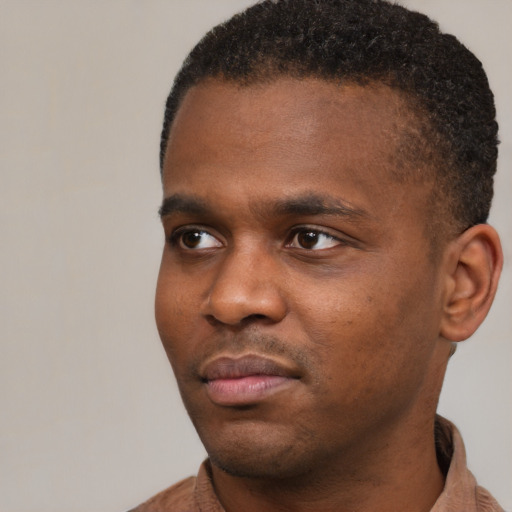 Neutral black young-adult male with short  black hair and brown eyes