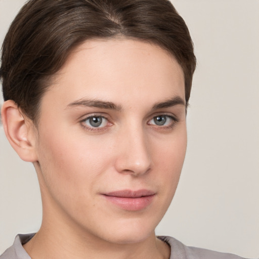 Joyful white young-adult female with short  brown hair and grey eyes