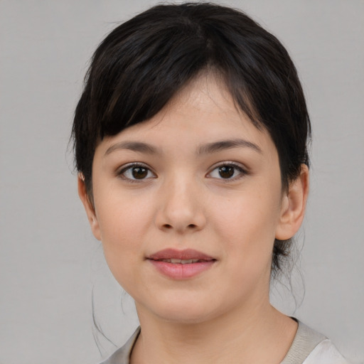 Joyful white young-adult female with medium  black hair and brown eyes