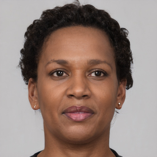 Joyful black adult female with short  brown hair and brown eyes