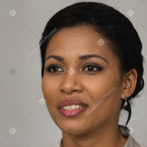 Joyful black young-adult female with long  black hair and brown eyes