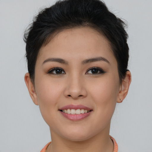 Joyful asian young-adult female with short  brown hair and brown eyes