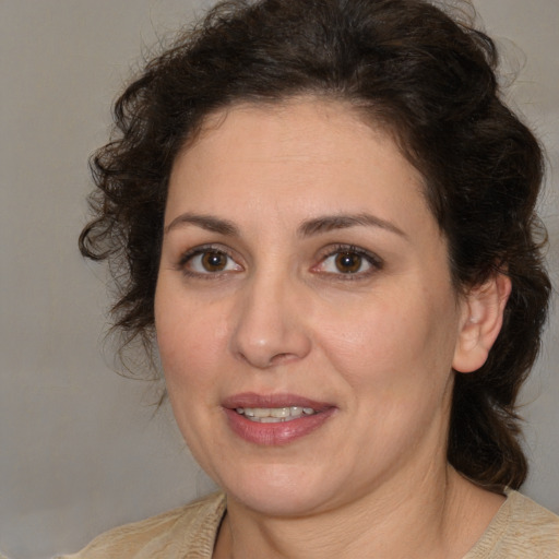 Joyful white adult female with medium  brown hair and brown eyes