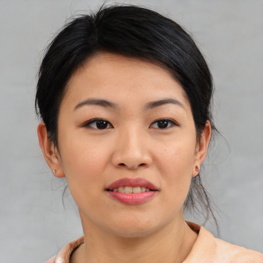 Joyful asian young-adult female with medium  black hair and brown eyes