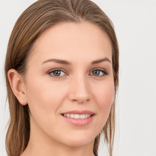 Joyful white young-adult female with long  brown hair and grey eyes