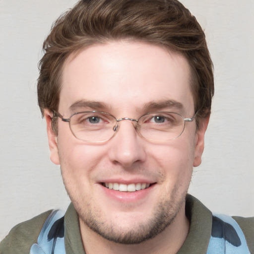 Joyful white adult male with short  brown hair and blue eyes