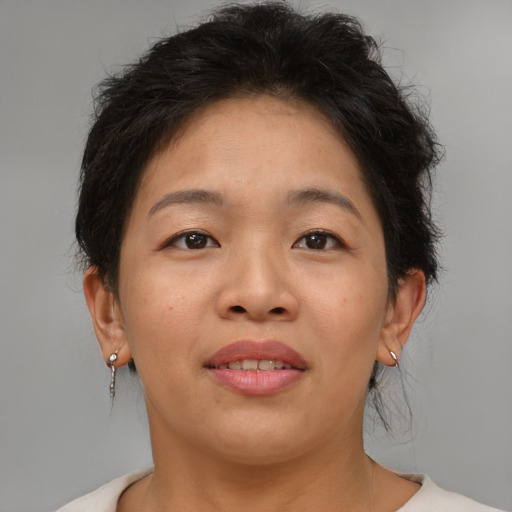 Joyful asian adult female with short  brown hair and brown eyes