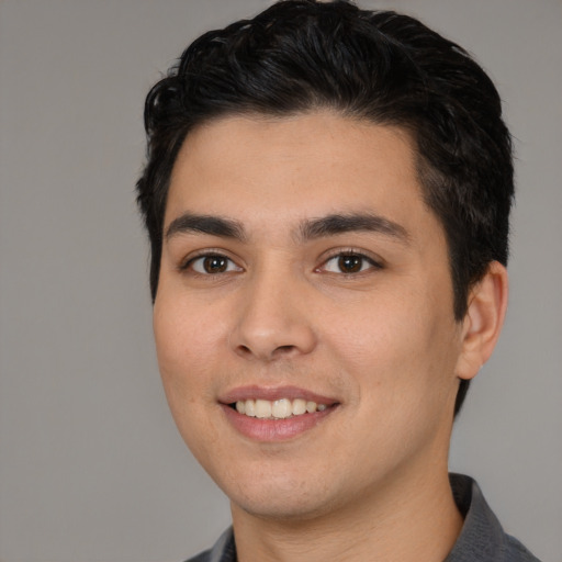 Joyful white young-adult male with short  black hair and brown eyes