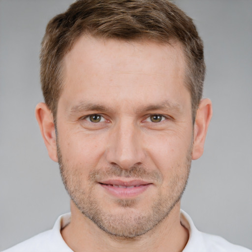 Joyful white adult male with short  brown hair and brown eyes