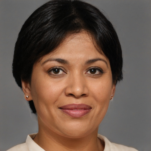 Joyful latino adult female with short  brown hair and brown eyes