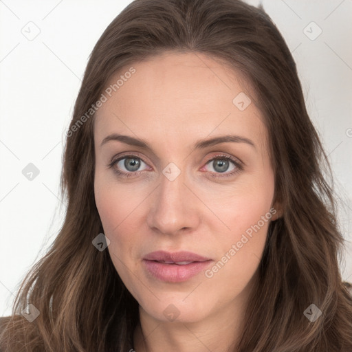 Joyful white young-adult female with long  brown hair and blue eyes