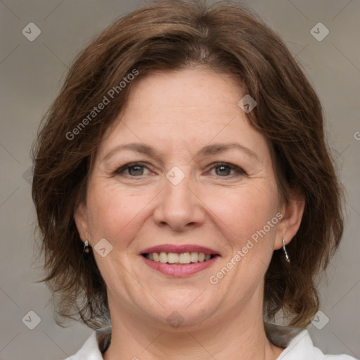 Joyful white adult female with medium  brown hair and grey eyes