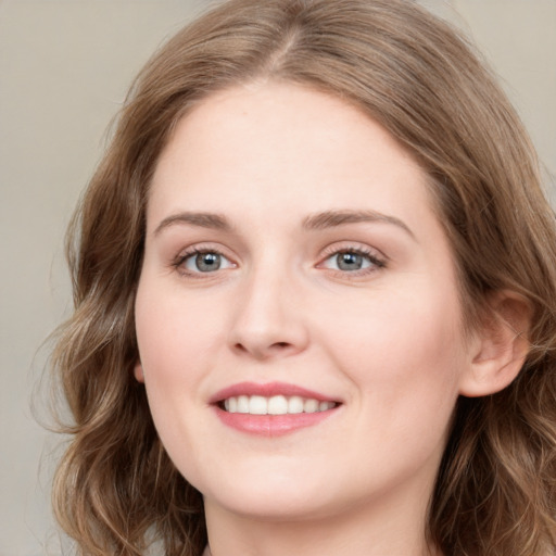 Joyful white young-adult female with medium  brown hair and green eyes