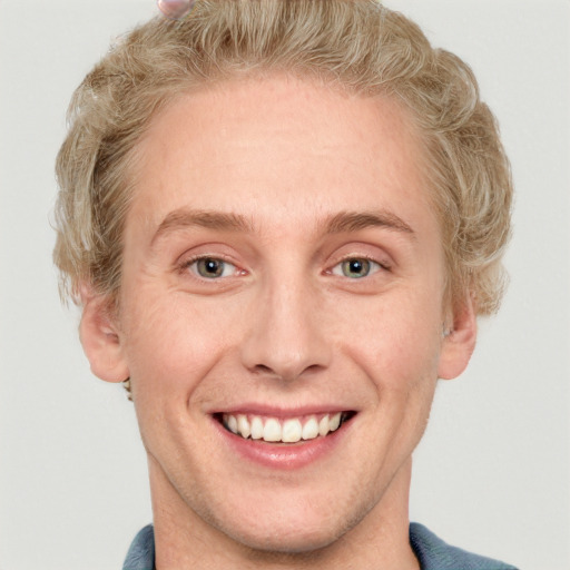 Joyful white adult male with short  brown hair and blue eyes