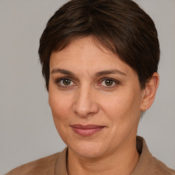 Joyful white adult female with short  brown hair and brown eyes