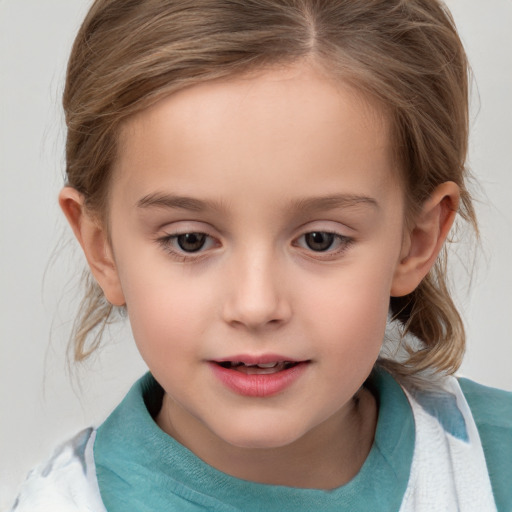 Joyful white child female with medium  brown hair and grey eyes