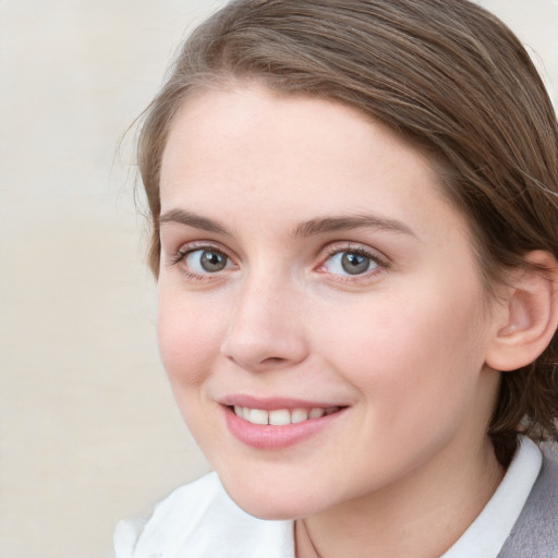 Joyful white young-adult female with medium  brown hair and blue eyes