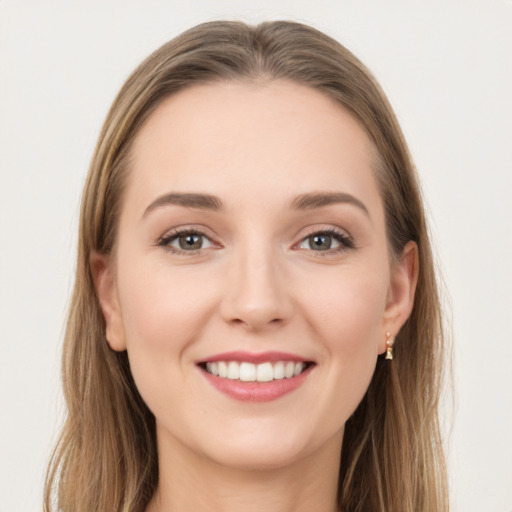 Joyful white young-adult female with long  brown hair and grey eyes