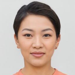 Joyful asian young-adult female with short  brown hair and brown eyes