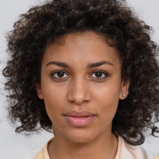 Neutral black young-adult female with medium  brown hair and brown eyes