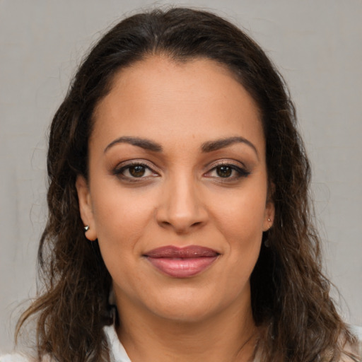 Joyful latino young-adult female with long  brown hair and brown eyes