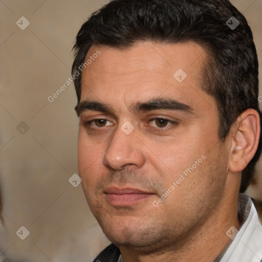 Joyful white adult male with short  black hair and brown eyes