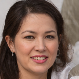 Joyful white adult female with long  brown hair and brown eyes