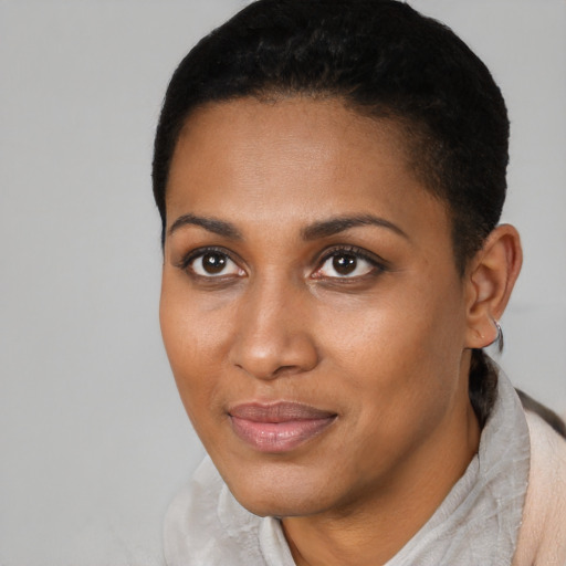 Joyful black young-adult female with short  black hair and brown eyes
