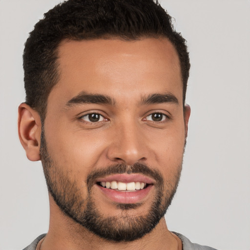 Joyful white young-adult male with short  brown hair and brown eyes