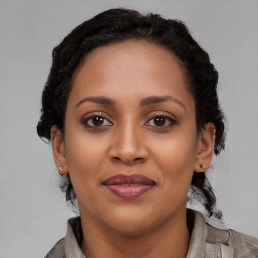 Joyful latino adult female with medium  brown hair and brown eyes