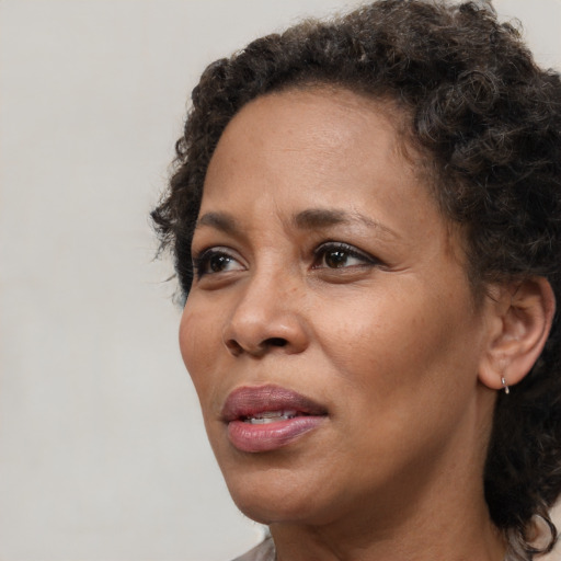 Joyful black adult female with short  brown hair and brown eyes