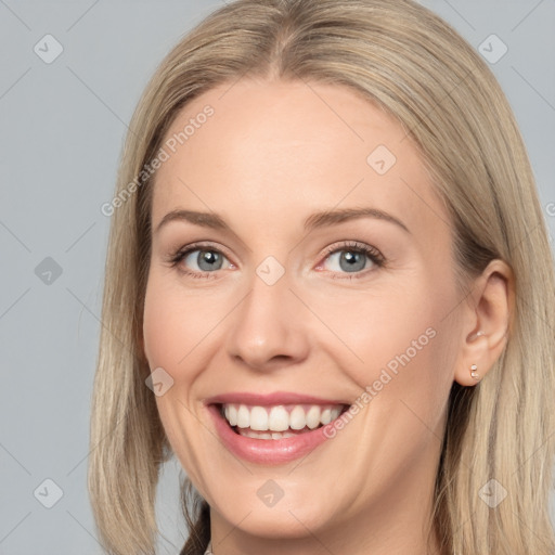 Joyful white adult female with long  brown hair and grey eyes