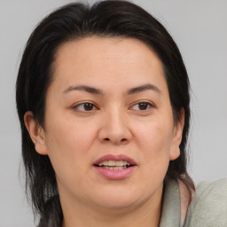 Joyful white adult female with medium  brown hair and brown eyes