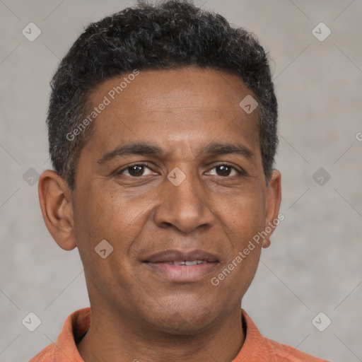 Joyful black adult male with short  brown hair and brown eyes
