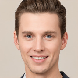 Joyful white young-adult male with short  brown hair and grey eyes