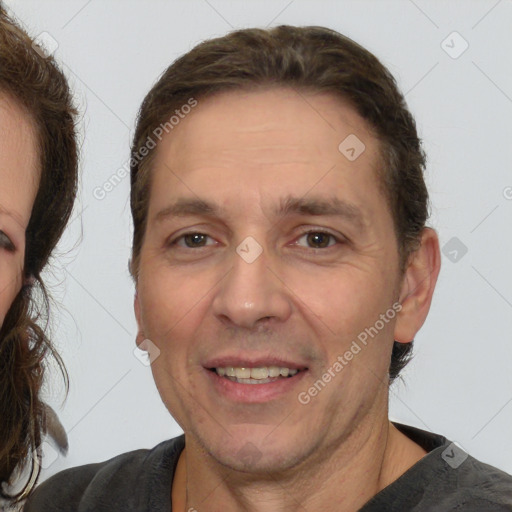 Joyful white adult male with short  brown hair and brown eyes