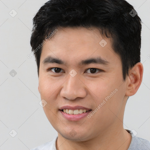 Joyful white young-adult male with short  black hair and brown eyes