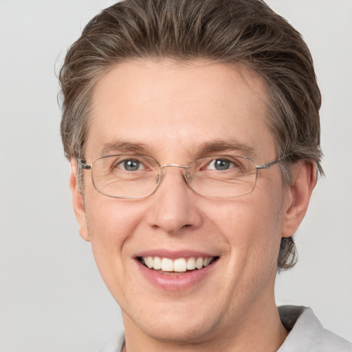 Joyful white adult male with short  brown hair and grey eyes