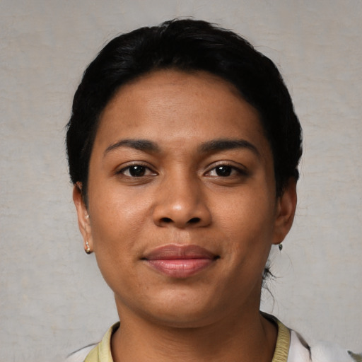 Joyful latino young-adult female with short  black hair and brown eyes