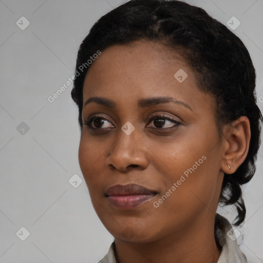 Joyful black young-adult female with short  black hair and brown eyes