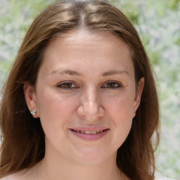 Joyful white young-adult female with medium  brown hair and grey eyes