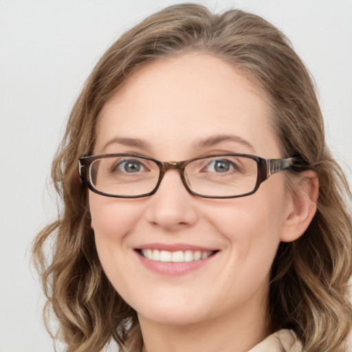 Joyful white young-adult female with medium  brown hair and blue eyes