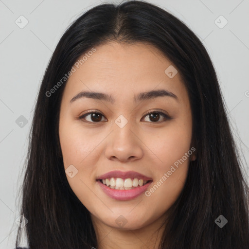 Joyful asian young-adult female with long  brown hair and brown eyes