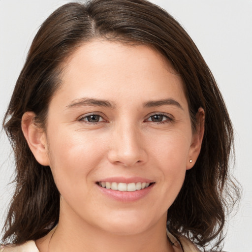 Joyful white young-adult female with medium  brown hair and brown eyes