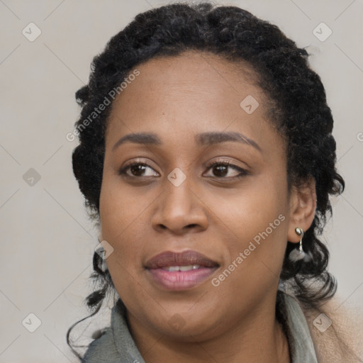 Joyful black young-adult female with long  black hair and brown eyes