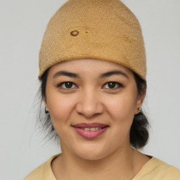 Joyful latino young-adult female with medium  brown hair and brown eyes